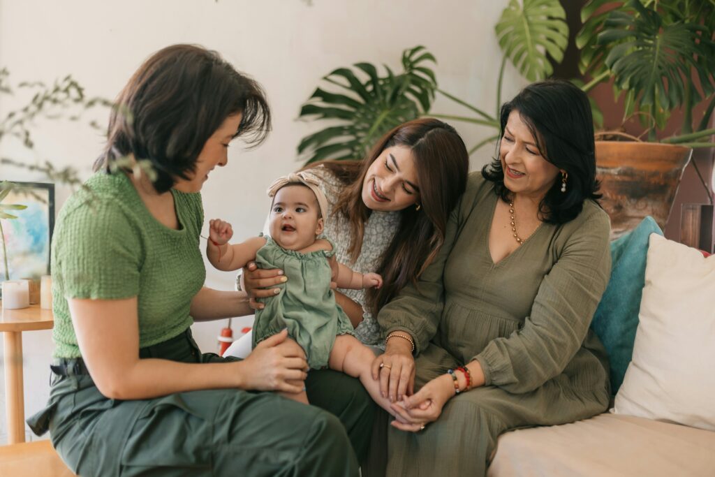 Three generations of women smiling together, symbolizing connection and the sandwich generation feeling lost in their 40s.