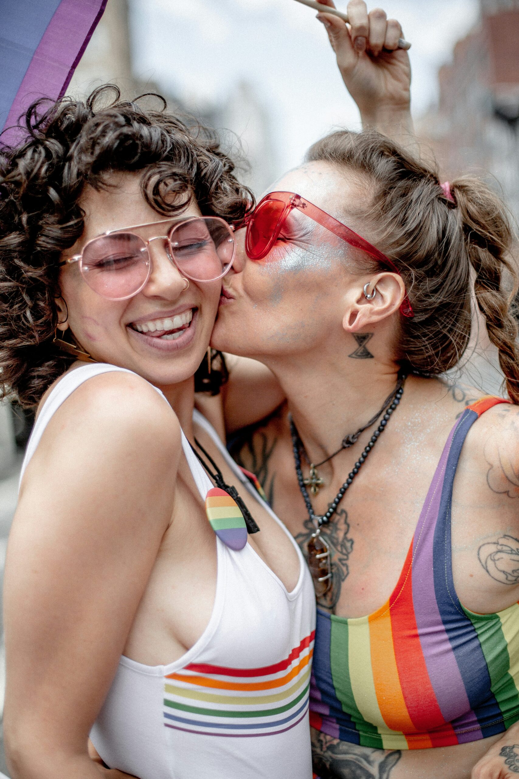 Two LGBTQ individuals at Pride celebration wearing rainbow pride attire, representing the importance of finding trans-affirming therapy in California with supportive providers like Theo Triplis